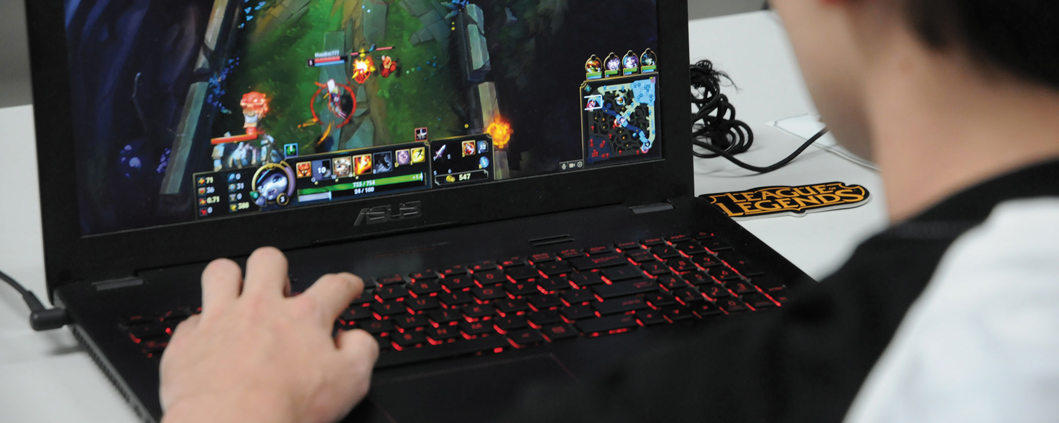 Student playing League of Legends on his laptop