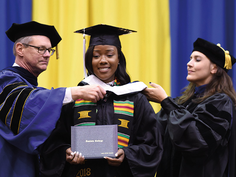 Aisha Nelson ’18 receives her hood during commencement